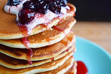 Delicious pancakes with sour cream and berries.