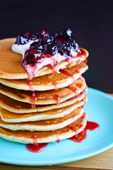 Delicious pancakes with sour cream and berries.