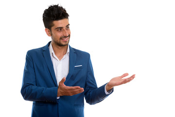 Young handsome bearded Persian businessman in suit