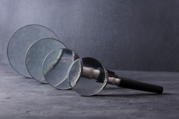 Closeup of line of different magnifiers against back background
