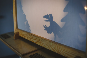 teacher do a shadow play crow in kindergarten or preschool. child play concept shadow pantomime...