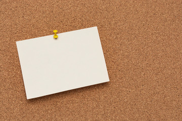 Note paper swith push pins on cork board. Empty paper pages for notes copy space