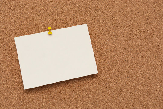 Note paper swith push pins on cork board. Empty paper pages for notes copy space