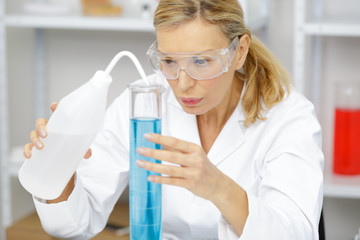 mature woman physician working with liquids in lab