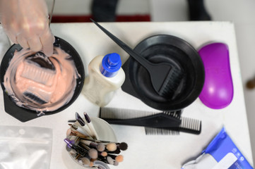 Studio photo of a set of tools of a makeup artist by a cosmetologist at a hairdresser. For creating beautiful makeup and hairstyle, rejuvenation of the skin of the face.