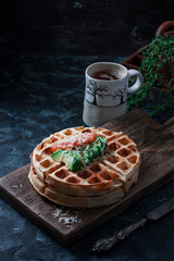 Cheese waffles with avocado, salted red fish for breakfast. An ideal breakfast for a healthy diet.