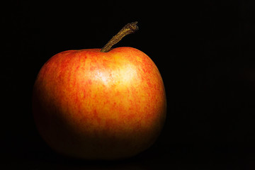 Yellow-red apple close-up on a dark background