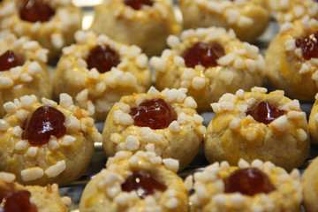 Traditional Austrian Husarenkrapferl lying on a grid Single sweet cookies with red marmalade decorated with sugar
