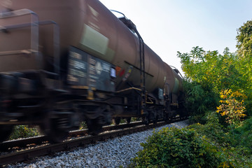 Obraz premium Freight train - wagon tanks, passing the railroad. Motion blur