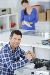 happy man is screwing a washer