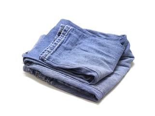 Stack of various blue jeans on white background.