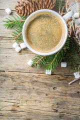 Fototapeta na wymiar Christmas winter coffee cup with marshmallow, Breakfast christmas morning concept. With xmas tree and decoration on rustic wooden background banner
