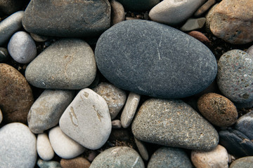 Fototapeta na wymiar Gravel pattern of colored stones. Abstract nature pebbles background. Stone background. Sea peblles beach. Top view.