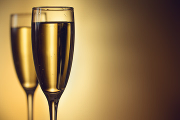 Two glasses of champagne on a blurred background. Celebration concept. Selective focus. Background with copy space.