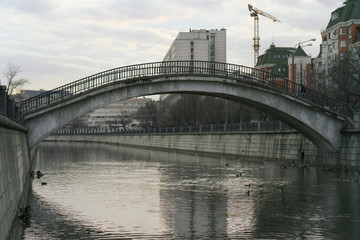 Photography of city street in downtown at cold autumn day. Sadovnicheskaya embankment and high small stone bridge view