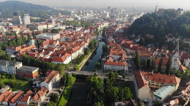 Ljubljanica river and Ljubljana city skyline. Aerial view, morning haze