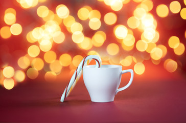 Cup with lollipop inside on bokeh background.