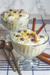 traditional creamy rice pudding with cinnamon, milk and raisins
