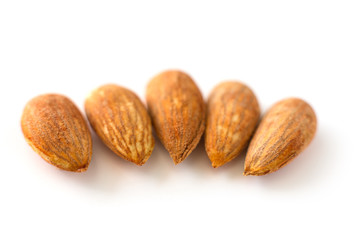 row, line of peeled young almonds on a white background, isolate, nut antioxidant