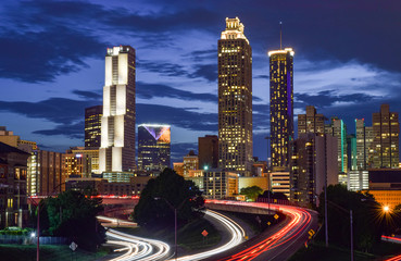 Fototapeta na wymiar Skyline of Downtown Atlanta and Blurred Highway Traffic at Dusk - Atlanta, Georgia, USA
