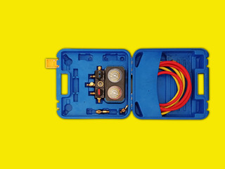 a blue tools box with special tool inside on yellow background isolated with clipping path