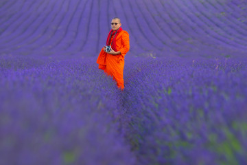 Fototapeta na wymiar Men in lavender fields, taking pictures and walking