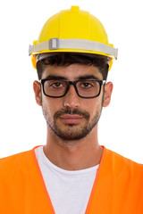 Face of young Persian man construction worker wearing eyeglasses
