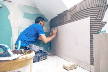 Tiler at work, house remodeling or renovation