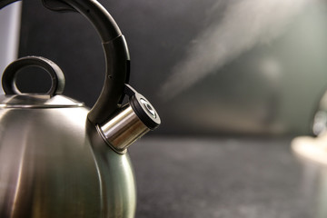 kettle with boiling water. whistle on a boiling kettle. a jet of steam from the boiling kettle....
