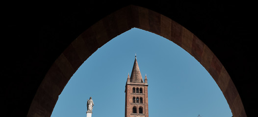 Fototapeta na wymiar view through arch of Cathedral with the adjoining baptistery and famous Torrazzo bell tower- Lombardy, Italy.