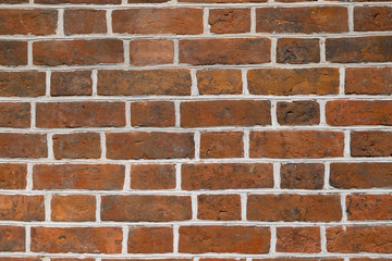 Texture of a red brick wall laid with white cement as a background