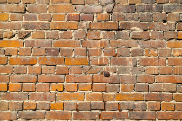 Texture of an old damaged brick wall with a big crack in it as a background