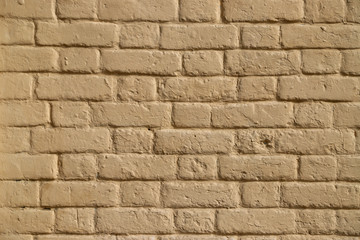 Texture of a brick wall painted in beige as a background