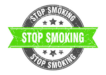 stop smoking round stamp with green ribbon. stop smoking