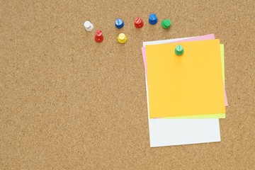 Sticky and pin blank paper notes on cork board to remind.