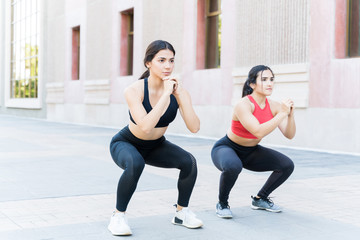 Obraz premium Young Caucasian Women Exercising Together