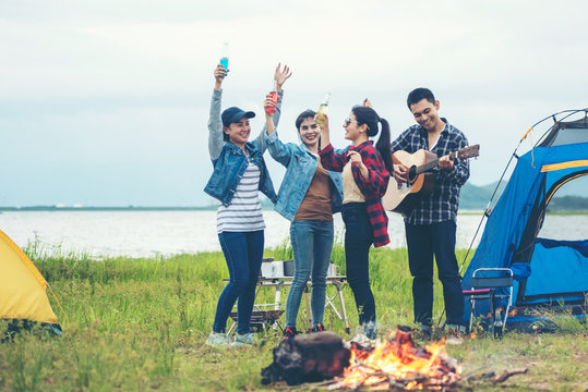 Party Camping.  Group Asian Family And Friends Travel Enjoy Party And Roasted Sausages Relax In Vacations. Campfire At Touristic Camp At Nature In Outdoor Forest.  Travel Concept