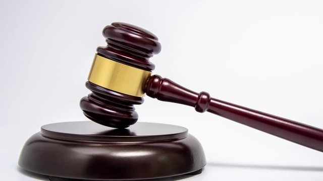 Zoom out. A wooden judge gavel on white background.