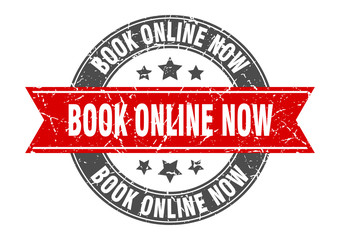book online now round stamp with red ribbon. book online now
