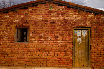 A humble house in bricks with a window and a door in the semiarid region of the state of Piauí, northeast of Brazil, drought and poor region