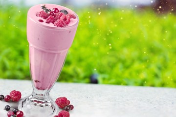 Composition of fruits and glasses of juice on natural background
