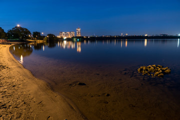 Fototapeta premium evening river cityscape with water reflections