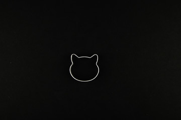 cat logo on a black background. Cat head logo. Abstract logo with a cat's head in black and white....