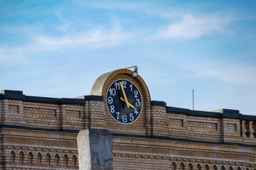 old street clock with arabic numbers