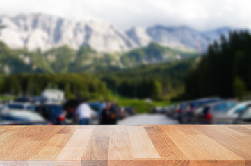 Empty wooden table top with blurred of with blurred nature, sky, cloud , mountaint and tourist background, can be used for display or montage your product.