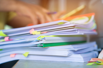 Businessman hands checking documents file paperwork financial market, searching information on work busy desk office. Piles of unfinished document achieves with pen for sigh. Business report  concept