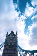 Fototapeta na wymiar The Tower Bridge in London against a blue sky with puffy white clouds.