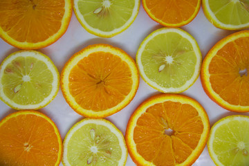 slices of orange and lemon on white, looks like a background