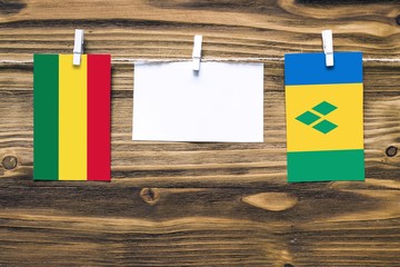 Hanging flags of Bolivia and Saint Vincent And The Grenadines attached to rope with clothes pins...