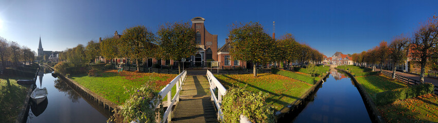 Canal in IJlst panorama during autumn in Friesland, The Netherlands